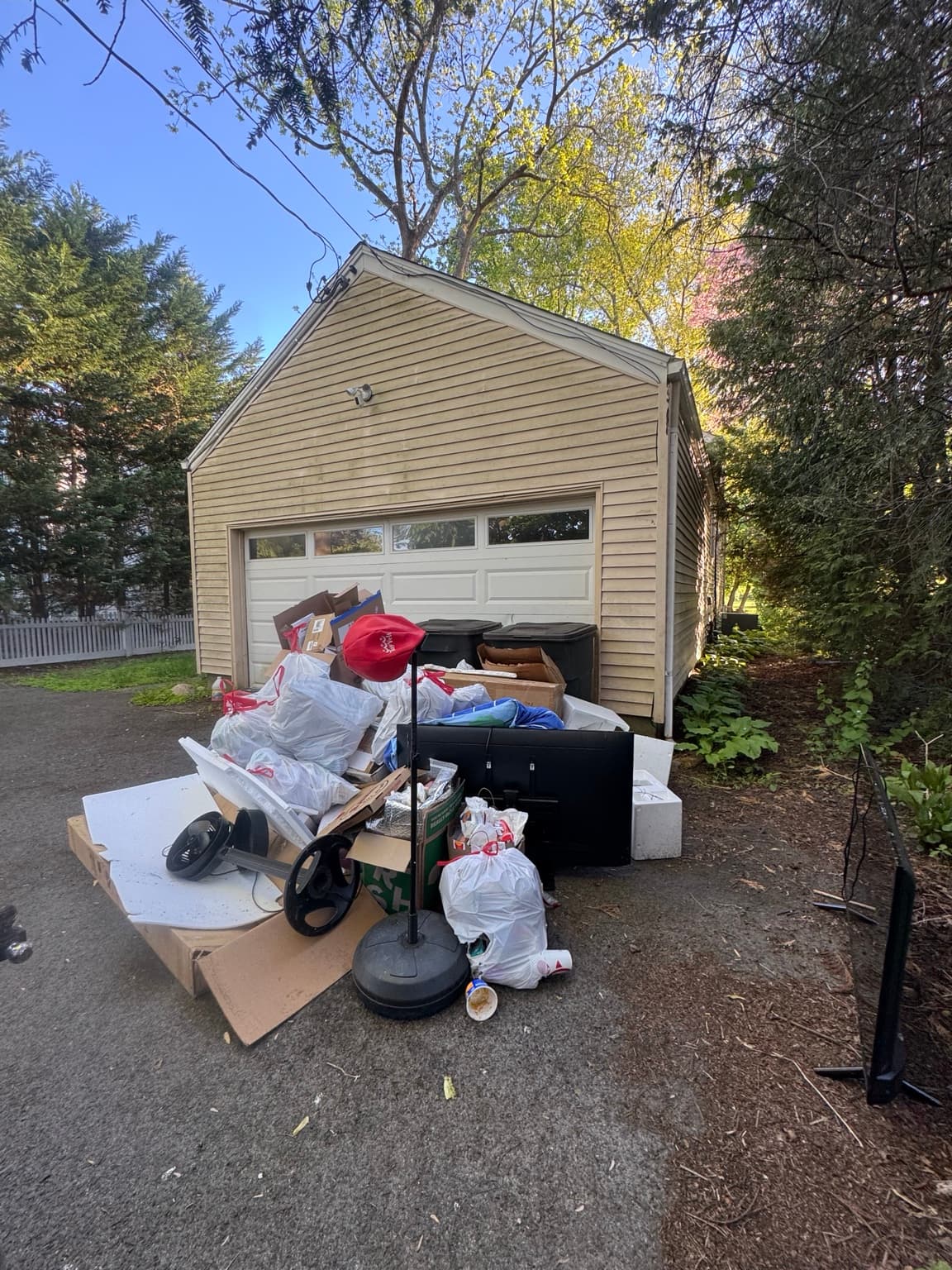 Household junk ready for Junkfire removal in a driveway
