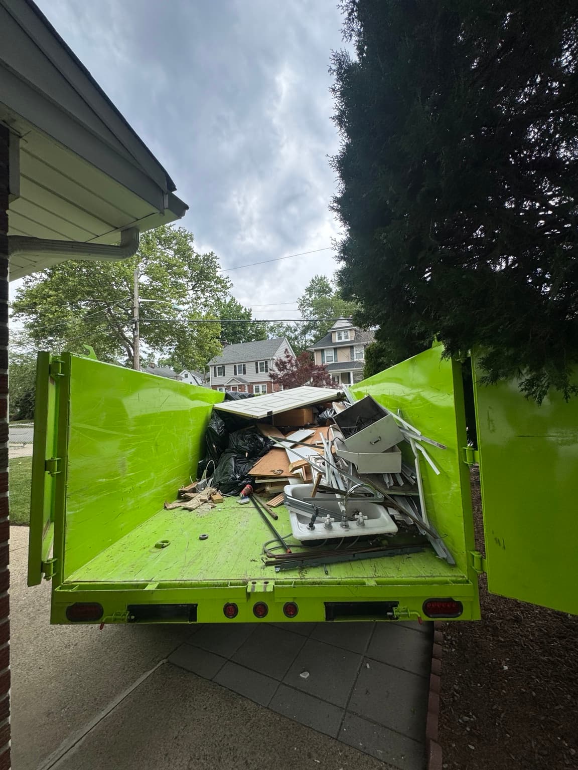 Bright green Junkfire trailer loaded with removed material